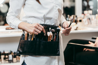Makeup artist wearing a brush belt