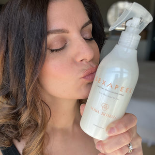 Woman kissing Sexapeel spray bottle