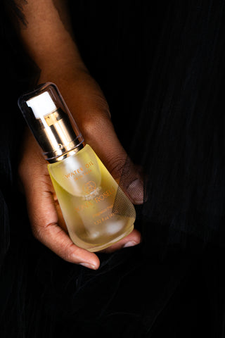 water oil in hand on black tulle