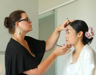 Sonia doing makeup on a client