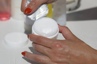 Freshly opening the lid of luxurious Water Balm Skin Prep, with Sonia Roselli skincare products in the background