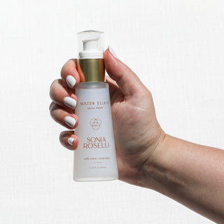 Water Elixir held in hands with white fingernails