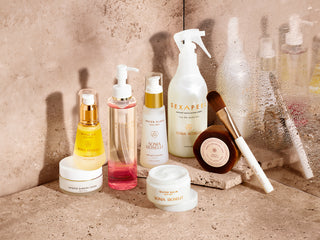 Full skincare line on stone top and water dropletts