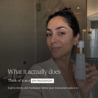 A woman in a beige robe holds a bottle of ASOIN DES PEURSUSS in front of a bathroom mirror. Text on the image reads 'What it actually does Think of it as a pre-moisturizer.