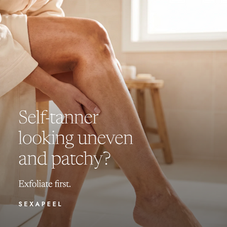 A person sitting in a bathroom with one leg raised, holding their thigh. Large text reads 'Self-tanner looking uneven and patchy? Exfoliate first.