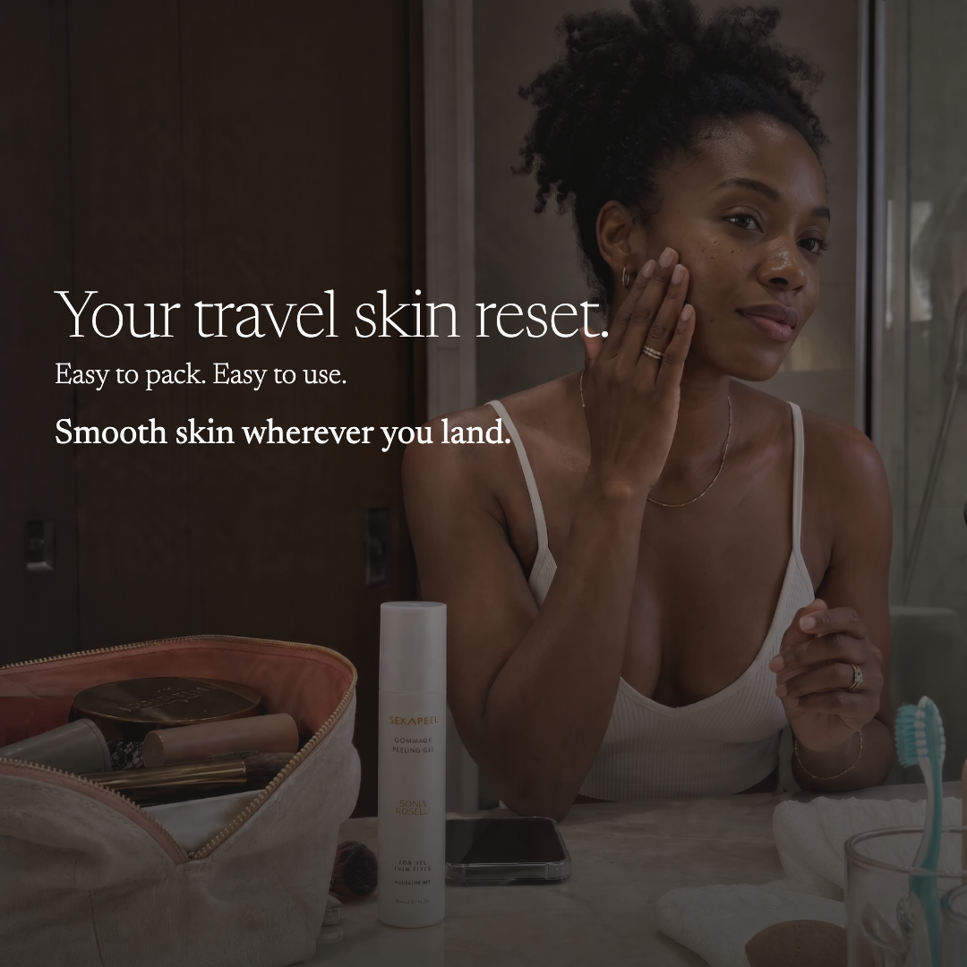 A woman in a white camisole sits in a bathroom setting, applying cream to her face. In the foreground, an open beige makeup bag and a white travel skin reset bottle are visible on a counter, with promotional text on the left.