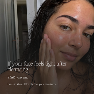 A close-up lifestyle shot of a woman with wet, damp skin touching her cheek, with overlaid text reading, 'If your face feels tight after cleansing / That's your cue. / Press in Water Elixir before your moisturizer.