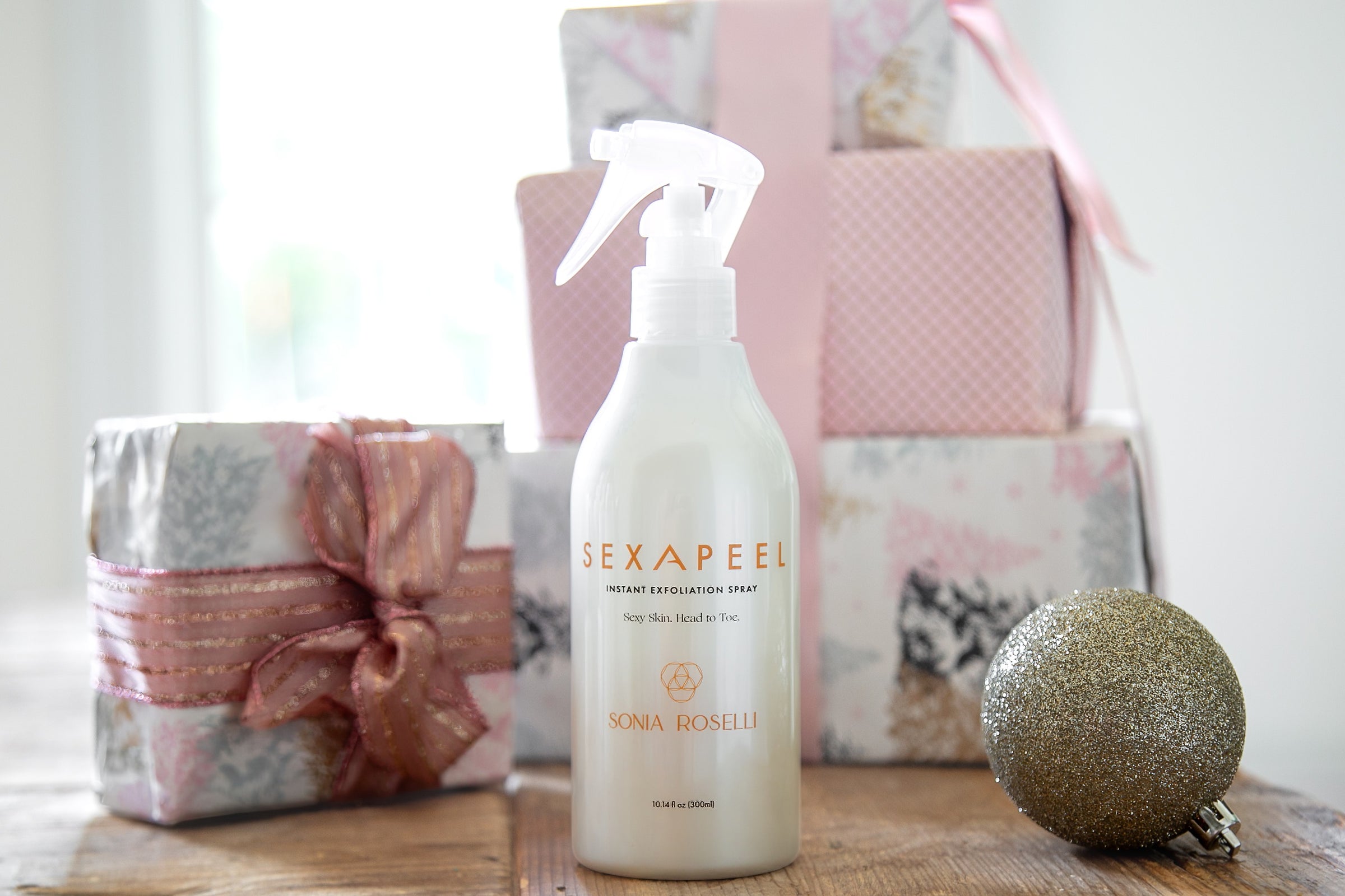 Sexapeel Spray with holiday gift background 