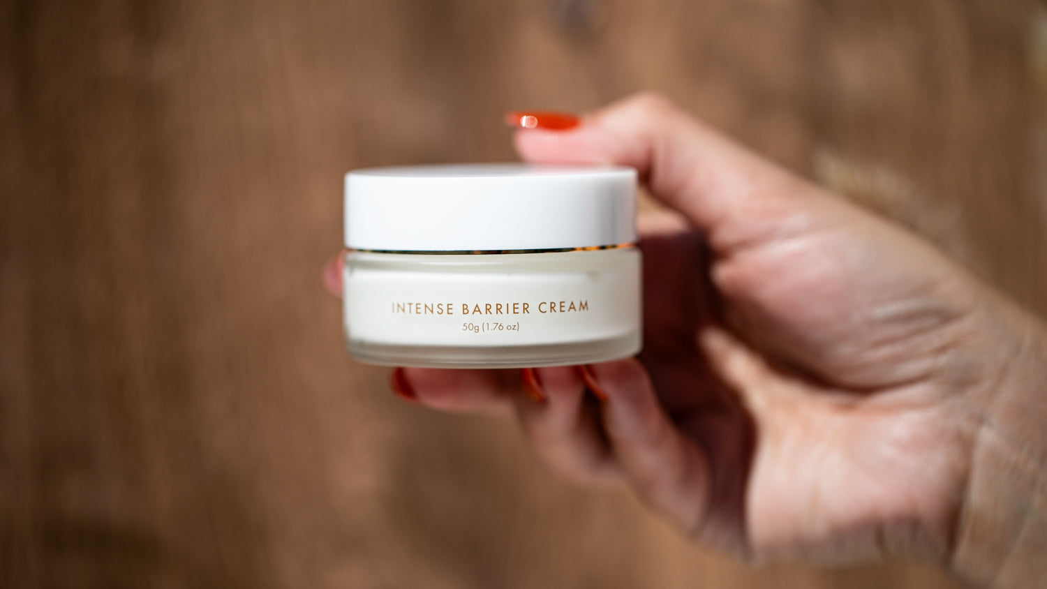 A jar of Sonia Roselli Beauty's Intense Barrier Cream takes the spotlight in this product photo. Its sleek packaging and pristine appearance convey the promise of powerful and protective skincare, offering a nourishing shield for your skin