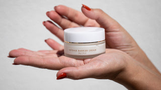 Intense Barrier Cream held in hands with red fingernails