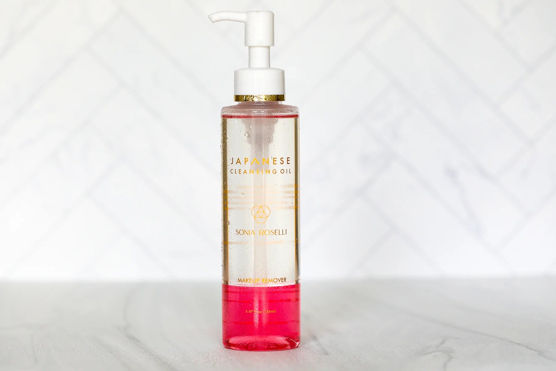 In a captivating product image, Sonia Roselli Beauty's Japanese Cleansing Oil, a versatile cleanser adept at removing SPF, makeup, and impurities, stands out with its elegant design. The product embodies the promise of gentle yet effective skincare, leaving your skin refreshed and radiant.