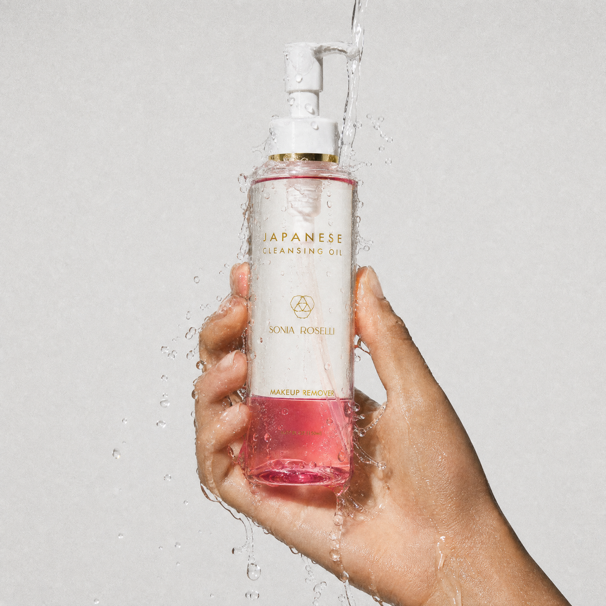 Japanese Cleansing Oil  with water splashing in hand