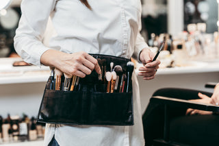 Makeup artist wearing a brush belt 