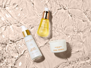 Sonia Roselli Beauty Water Elixir, Water Oil, and Water Balm arranged on a rippling water background symbolizing hydration and a healthy skin barrier.