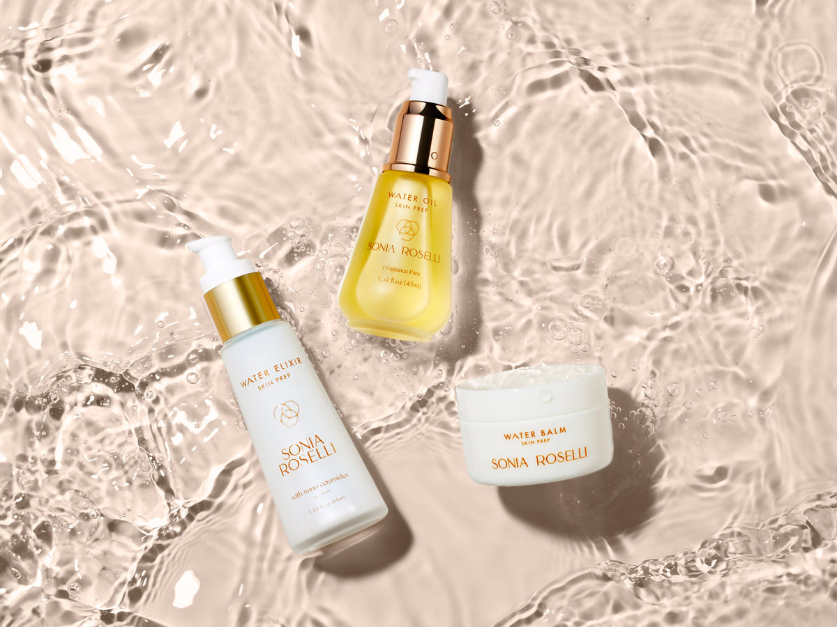 Sonia Roselli Beauty Water Elixir, Water Oil, and Water Balm arranged on a rippling water background symbolizing hydration and a healthy skin barrier.