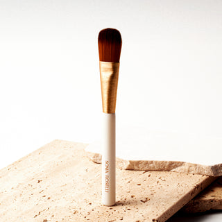 skincare brush on stone surface