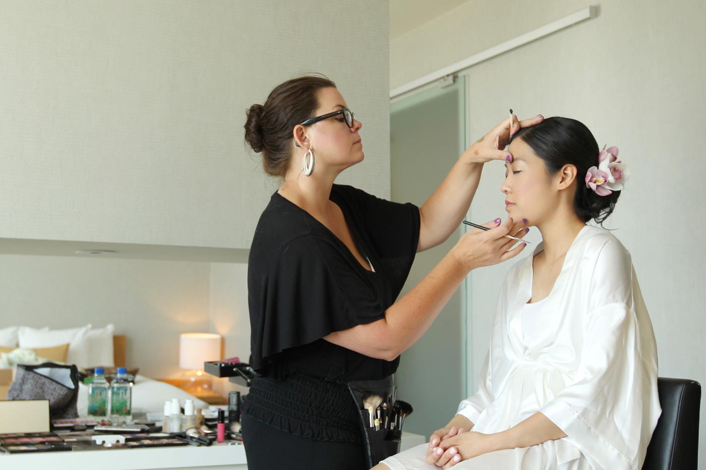 Sonia Roselli applying makeup to a bride-to-be.
