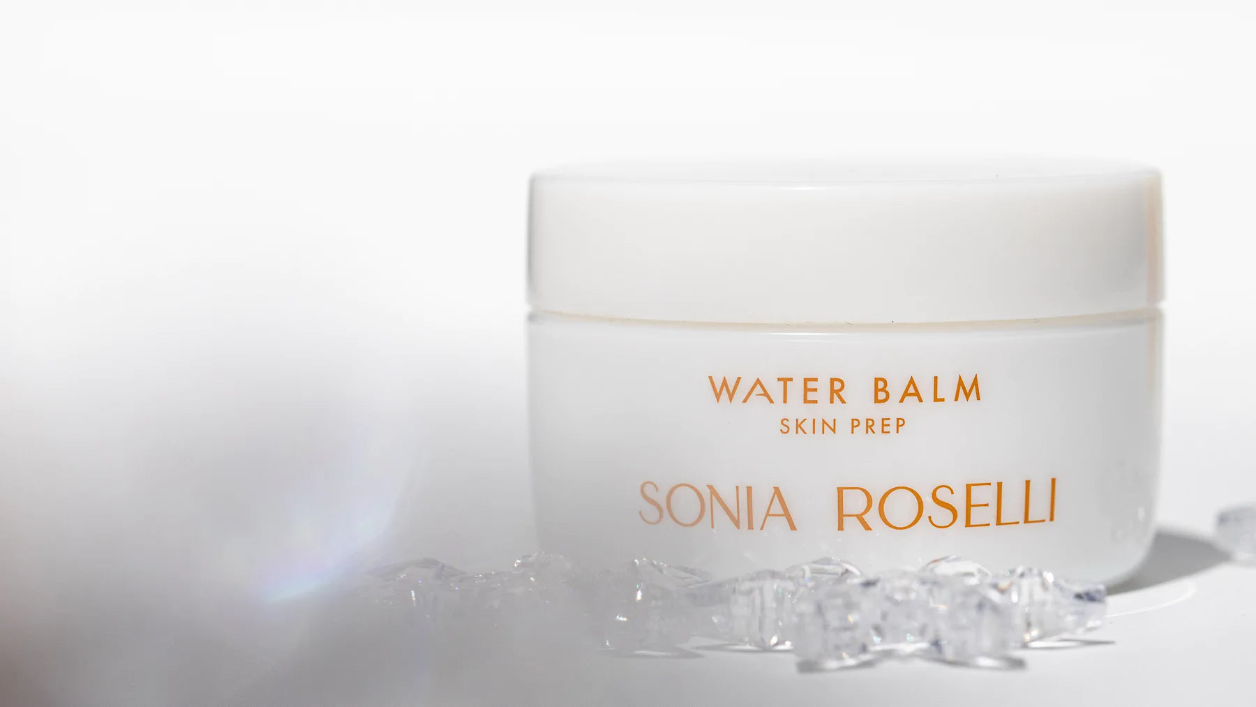 Water Balm moisturizer on white background with transparent crystals
