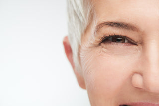 mature woman with blonde hair showing close up fine lines near eyes