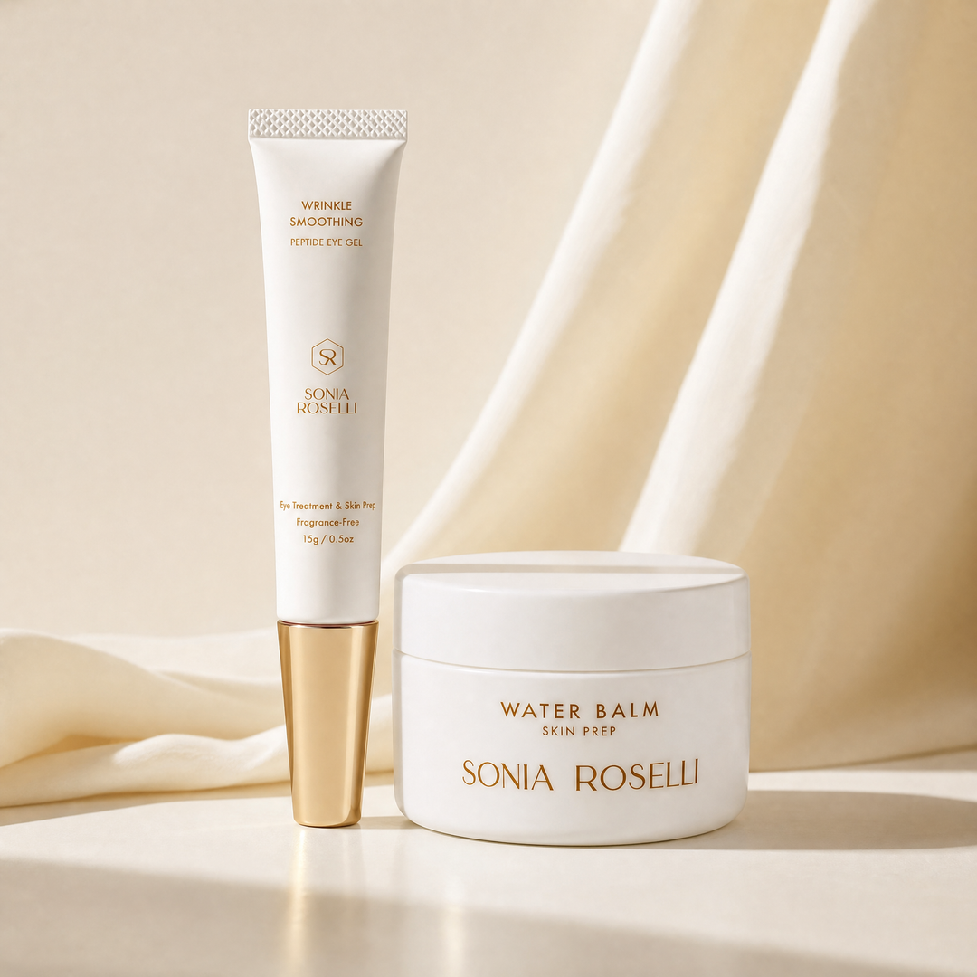 Sonia Roselli skincare set featuring a white tube of Wrinkle Smoothing Peptide Eye Oil with a gold cap, and a white jar of Water Balm Skin Prep, styled on a cream surface with draped cream fabric.