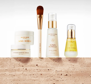 Sonia Roselli skincare products including bottles and a brush on a beige background