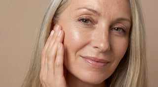 Mature woman with radiant complexion demonstrating the results of barrier-repair skincare for sensitive skin.