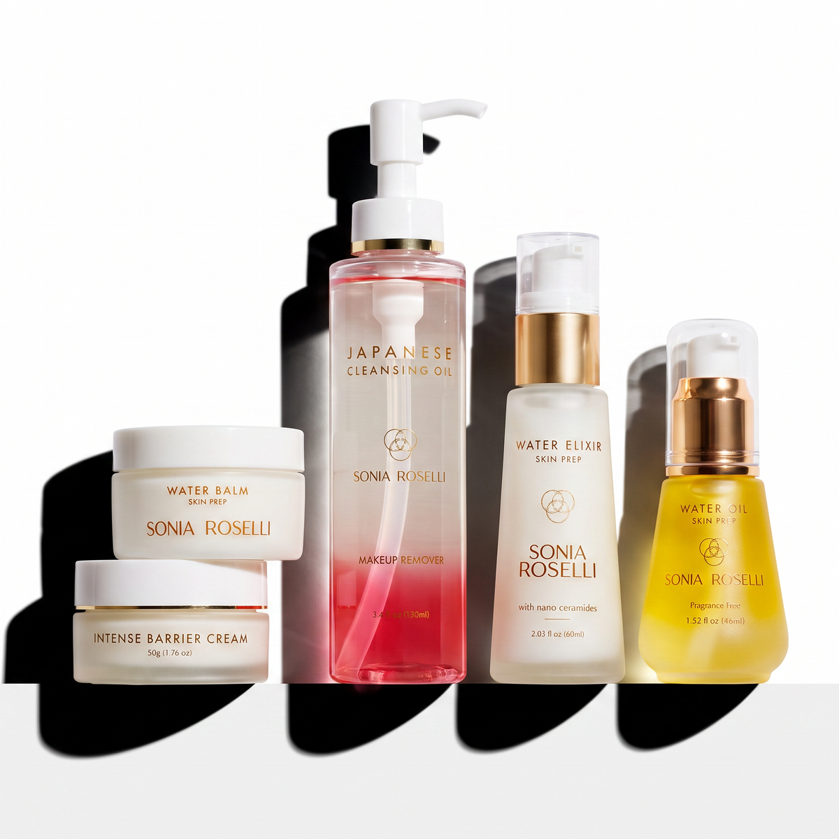 Five Sonia Roselli skincare bottles and jars arranged on a white surface with strong black shadows against a white background. The products include Water Balm, Intense Barrier Cream, Japanese Cleansing Oil, Water Elixir, and a yellow-toned serum or oil, each labeled with the Sonia Roselli brand.