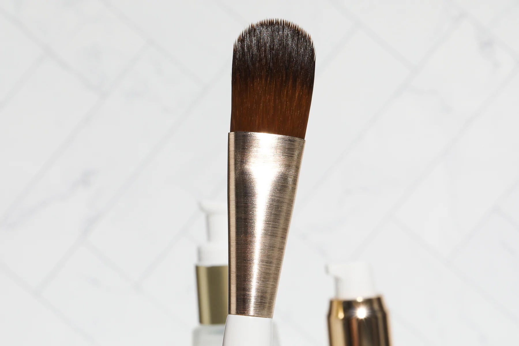 Skin prep brush head in focus with other products in the background 