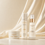 Three Sonia Roselli skincare products arranged on a draped cream satin fabric background: a Water Balm jar, a Cloud-Make Peeling Gel bottle, and a Water Elixir Glow Spray bottle with a metallic gold collar.