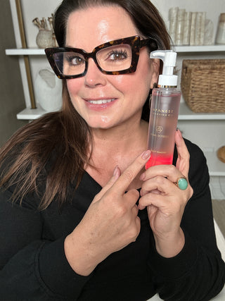 Sonia Roselli, licensed esthetician and founder of Sonia Roselli Beauty, holding the Japanese Cleansing Oil — a barrier-safe oil cleanser and makeup remover formulated in Japan with rice bran oil and camellia extract for sensitive skin