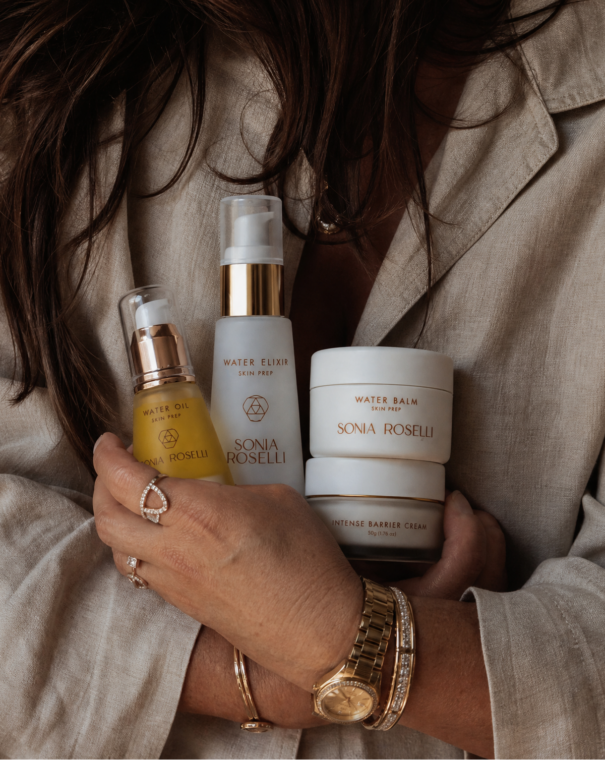 Person holding skincare products from Sonia Boselli brand