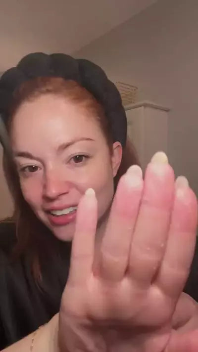 Woman applying exfoliant to her face