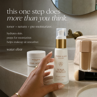 A hand reaches for a white Sonia Roselli Skin Prep Water Elixir pump bottle on a bathroom counter, with a white Water Balm jar, makeup brush, and makeup palette nearby. Text on the left reads, 'this one step does more than you think.