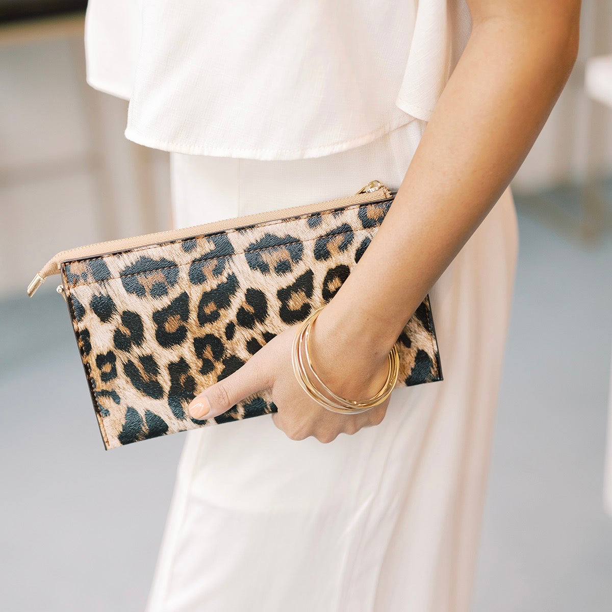 Woman carrying leopard print clutch purse